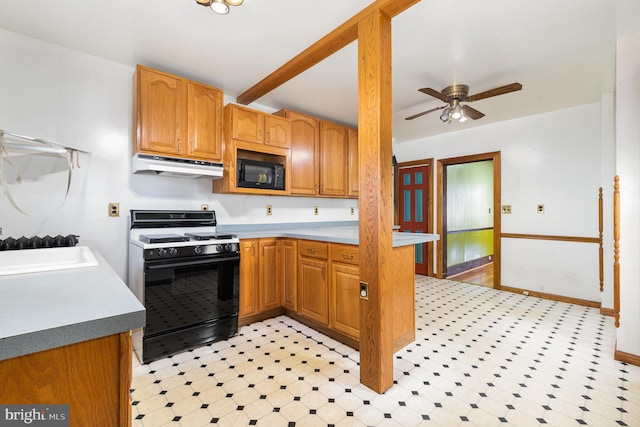 kitchen with under cabinet range hood, range with gas stovetop, light floors, and black microwave