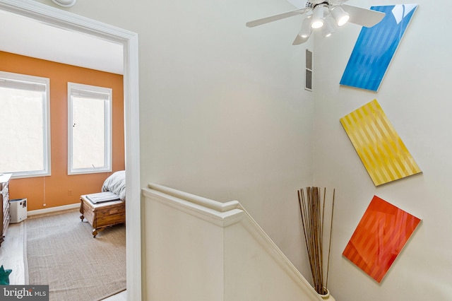 corridor with baseboards and an upstairs landing