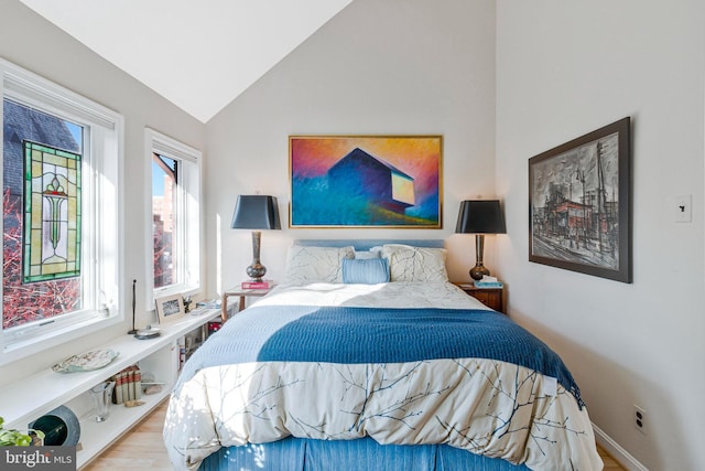 bedroom featuring vaulted ceiling and baseboards