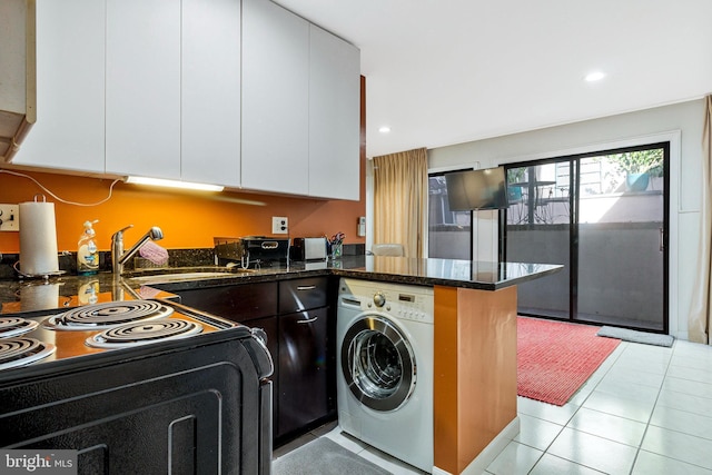 clothes washing area featuring a sink, washer / dryer, light tile patterned flooring, and recessed lighting