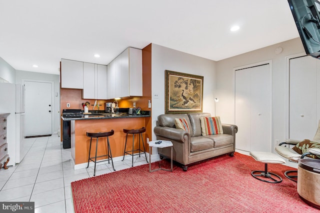 living room with light tile patterned flooring and recessed lighting