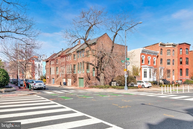 view of street featuring curbs, street lights, and sidewalks