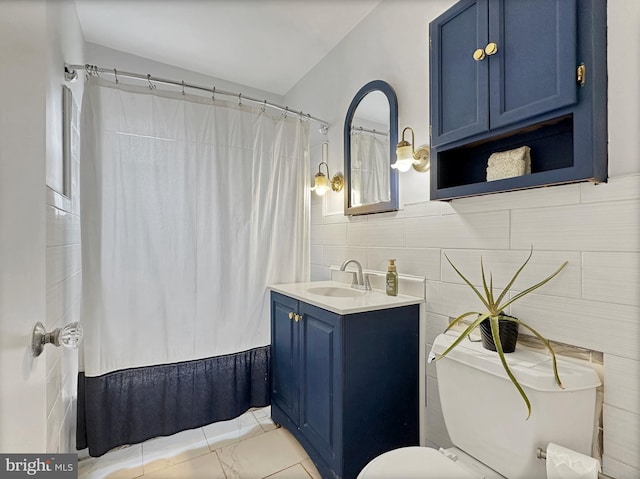 full bath featuring vanity, a shower with shower curtain, tile walls, toilet, and marble finish floor