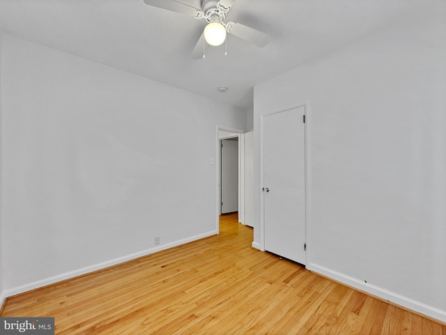 unfurnished bedroom with wood finished floors, baseboards, and ceiling fan