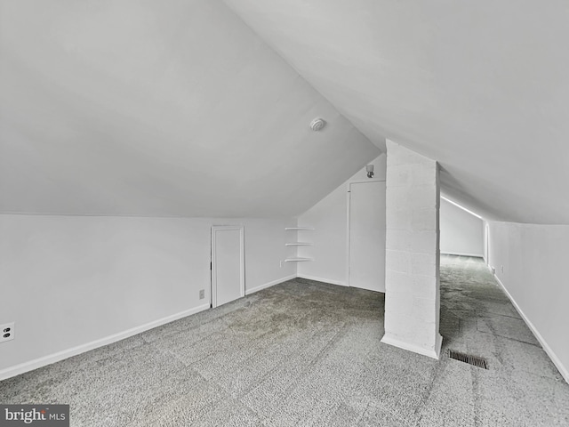 bonus room with vaulted ceiling, visible vents, baseboards, and carpet floors