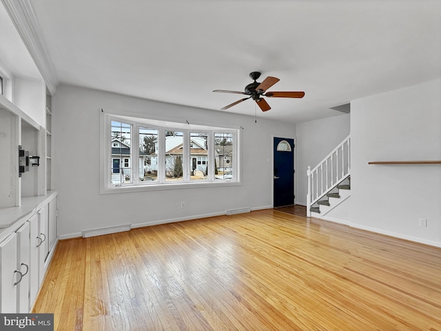 unfurnished living room featuring stairs, a ceiling fan, visible vents, and light wood-type flooring