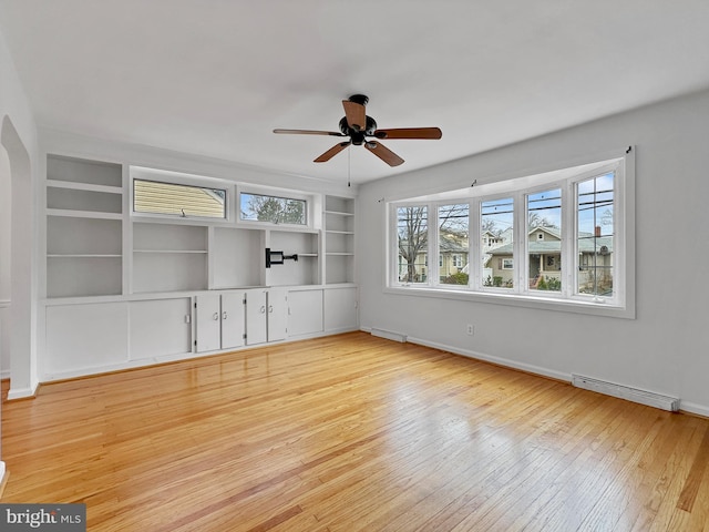 unfurnished living room with visible vents, a ceiling fan, built in features, light wood-style floors, and baseboards