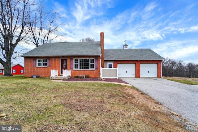 single story home with driveway, a front yard, a garage, brick siding, and a chimney