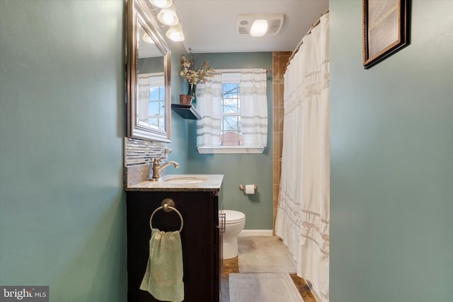 full bathroom featuring toilet, tasteful backsplash, a shower with shower curtain, baseboards, and vanity