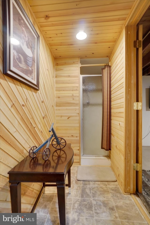 full bath with wooden walls, a shower stall, and wooden ceiling