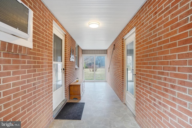 doorway to property with brick siding