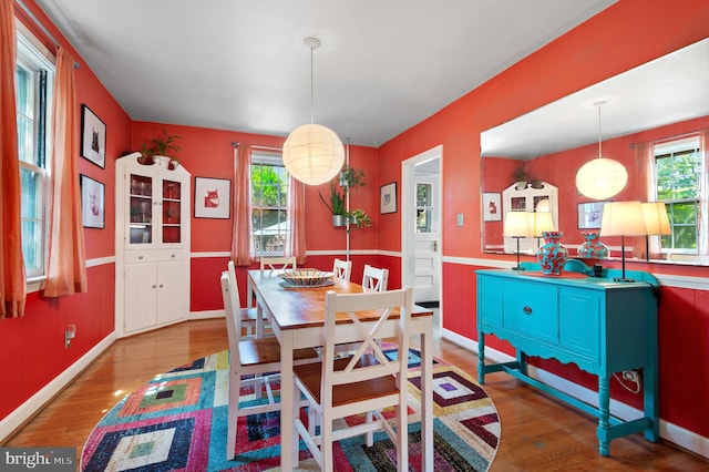 dining area with wood finished floors