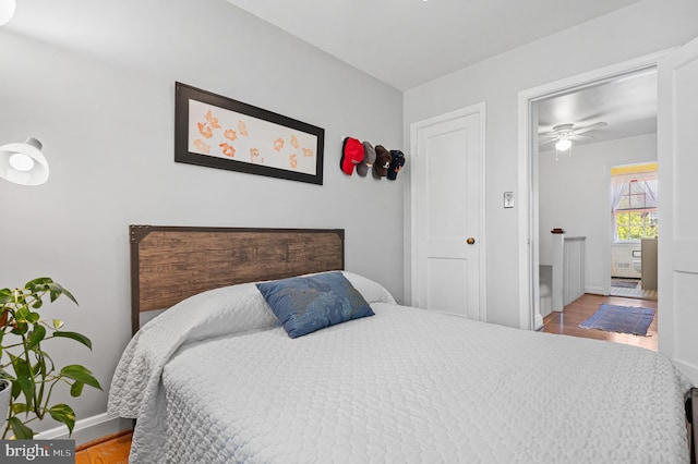 bedroom with baseboards and wood finished floors