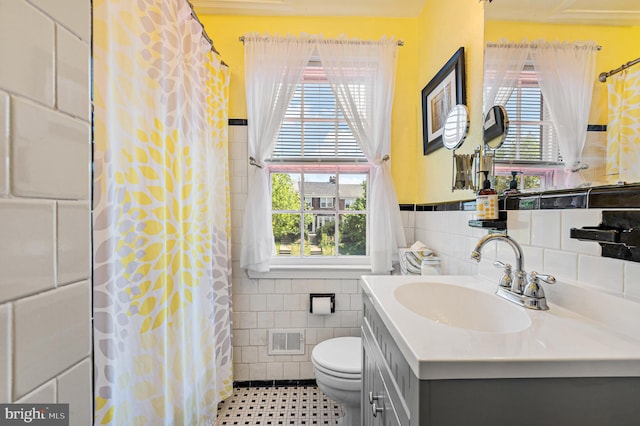 full bath with tile walls, visible vents, toilet, and a wealth of natural light