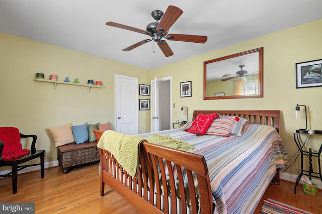 bedroom with baseboards, ceiling fan, and wood finished floors