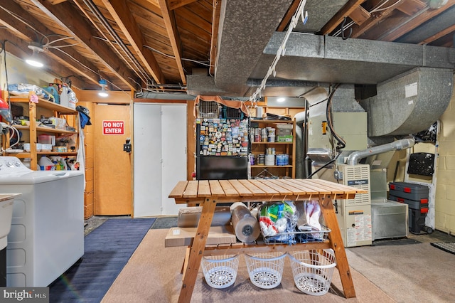 unfinished basement with heating unit and washing machine and dryer