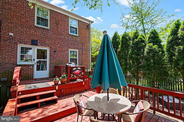 wooden terrace featuring fence and outdoor dining area
