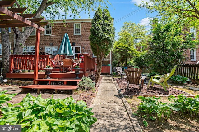 exterior space featuring brick siding and a wooden deck