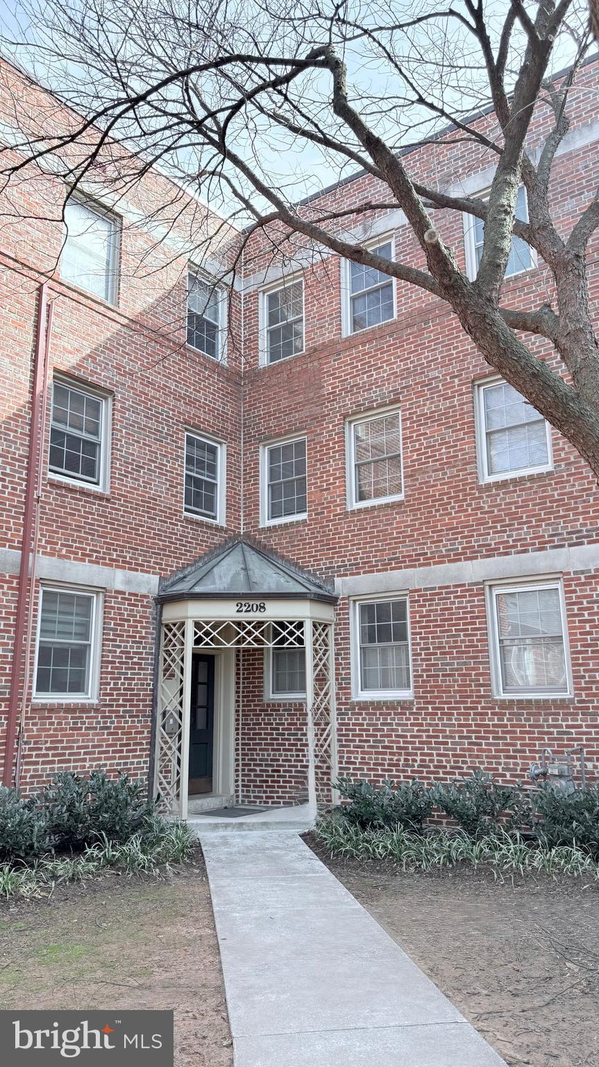 view of property featuring brick siding