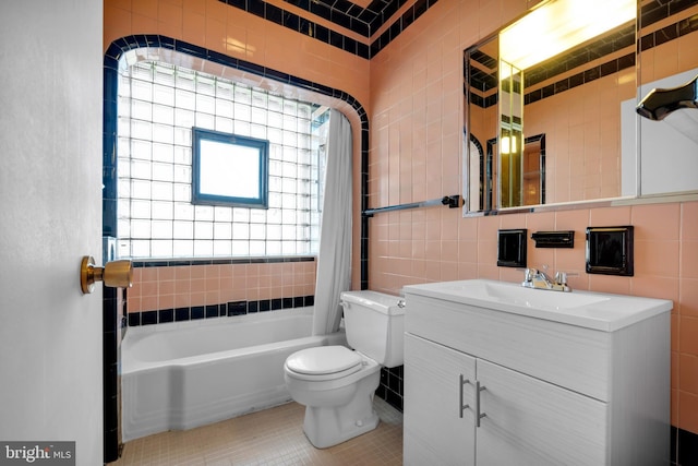 full bathroom featuring a healthy amount of sunlight, tile walls, and toilet