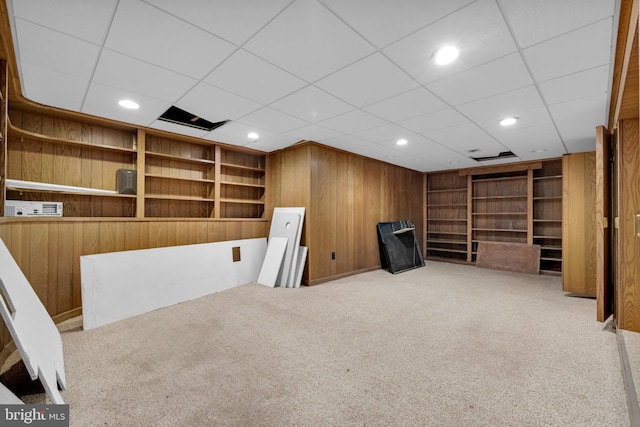 unfurnished room featuring recessed lighting, wooden walls, carpet flooring, and built in features