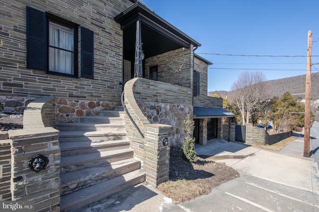 view of side of home featuring stone siding