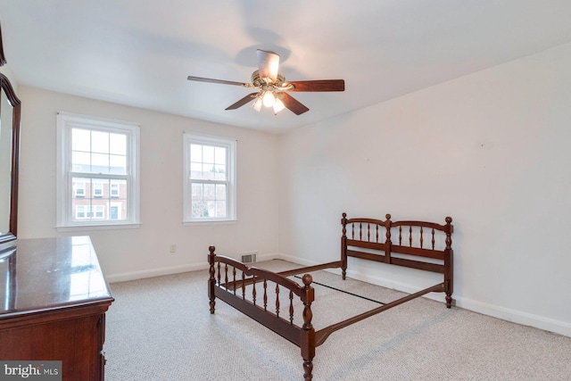 bedroom with a ceiling fan, carpet, visible vents, and baseboards