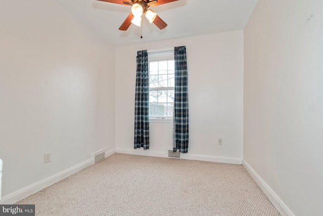 empty room featuring baseboards, visible vents, a ceiling fan, and carpet