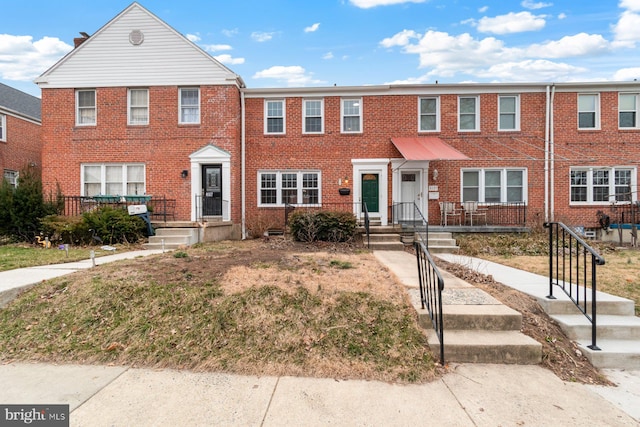 view of property featuring brick siding