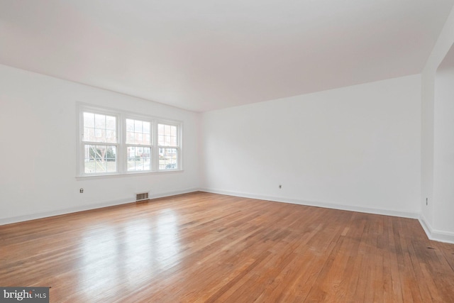 unfurnished room with visible vents, baseboards, and light wood-style floors