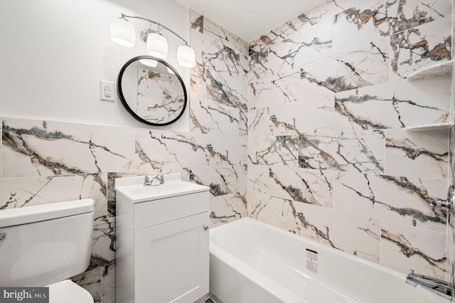 bathroom with vanity, tile walls, toilet, and shower / washtub combination