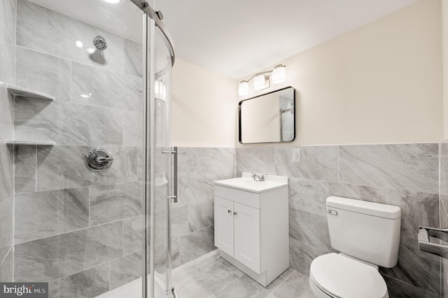 bathroom featuring toilet, a stall shower, and vanity