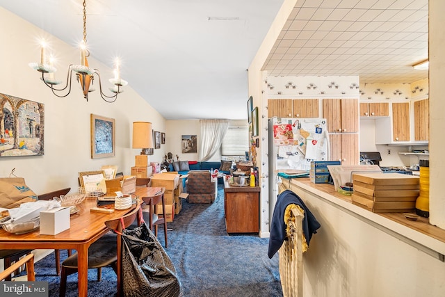 carpeted dining room with a chandelier and vaulted ceiling