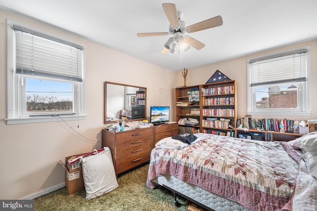 carpeted bedroom featuring baseboards