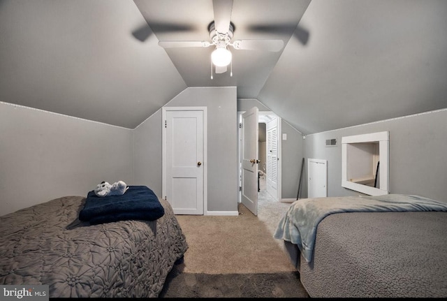 bedroom with visible vents, ceiling fan, carpet flooring, and vaulted ceiling