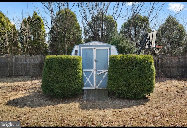 view of shed featuring fence