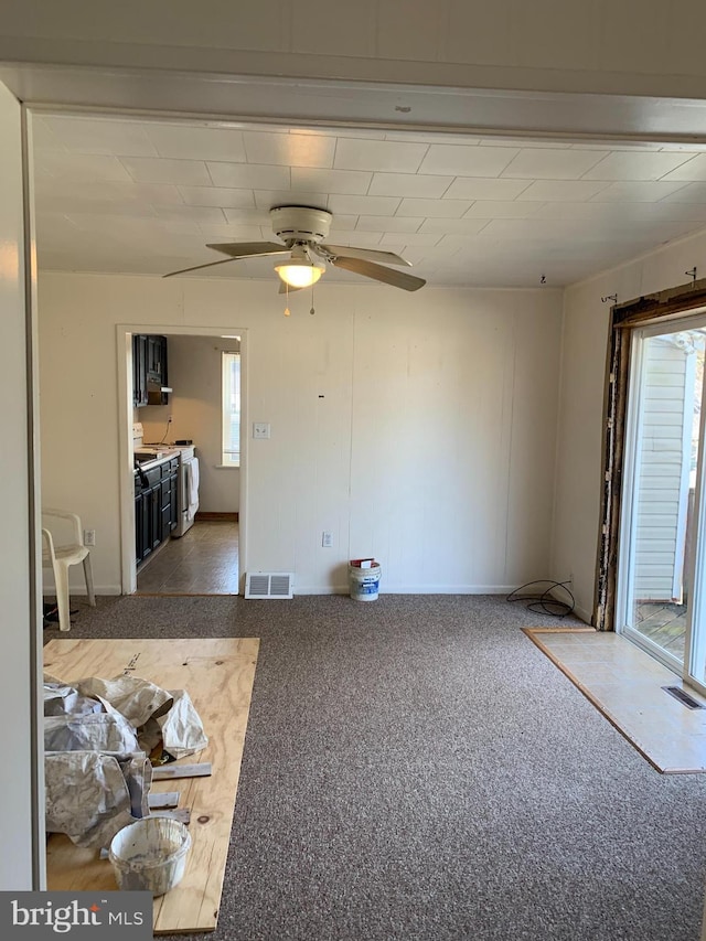 interior space featuring washer / clothes dryer, carpet, visible vents, and ceiling fan