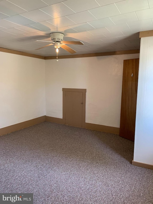 unfurnished room featuring carpet flooring, ceiling fan, and baseboards