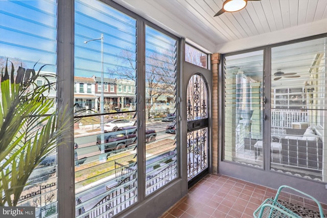 sunroom featuring ceiling fan