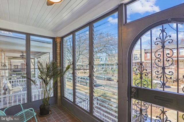 sunroom / solarium featuring wooden ceiling and ceiling fan