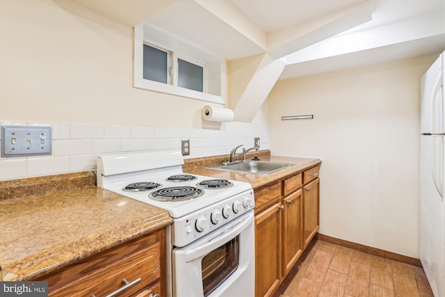 kitchen featuring backsplash, light wood-type flooring, brown cabinetry, white appliances, and a sink