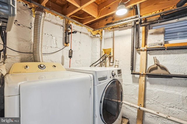 clothes washing area with washing machine and clothes dryer and laundry area