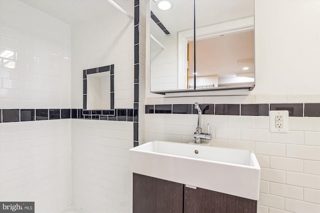 bathroom with a sink and tile walls