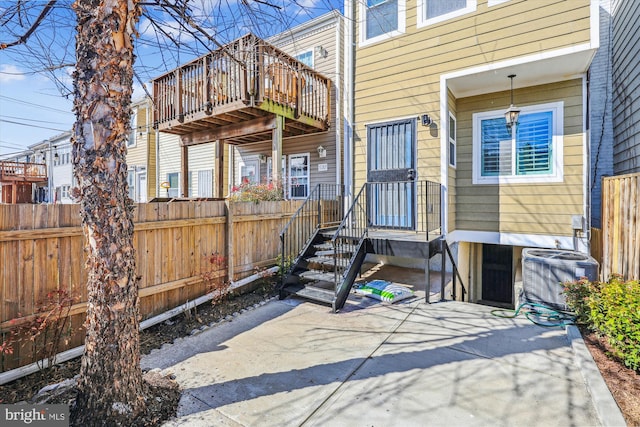 entrance to property with central AC unit and fence