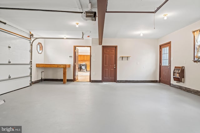 garage with heating unit, baseboards, and a garage door opener