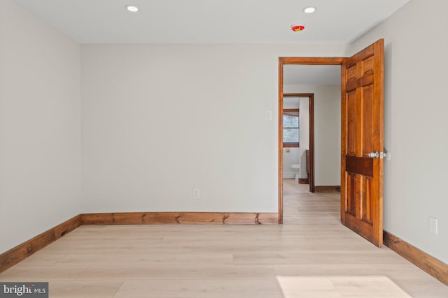 empty room with baseboards, light wood-style floors, and recessed lighting
