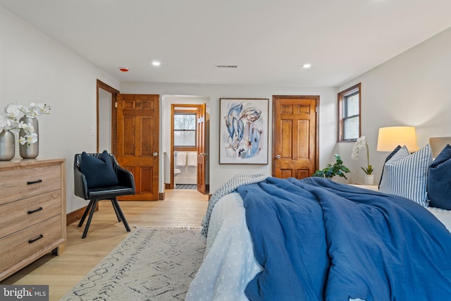 bedroom with light wood finished floors, multiple windows, and recessed lighting
