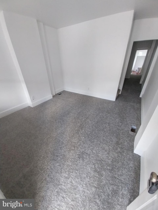 unfurnished living room featuring carpet floors