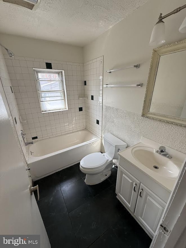 full bath featuring toilet, a textured ceiling, vanity, and shower / bathing tub combination