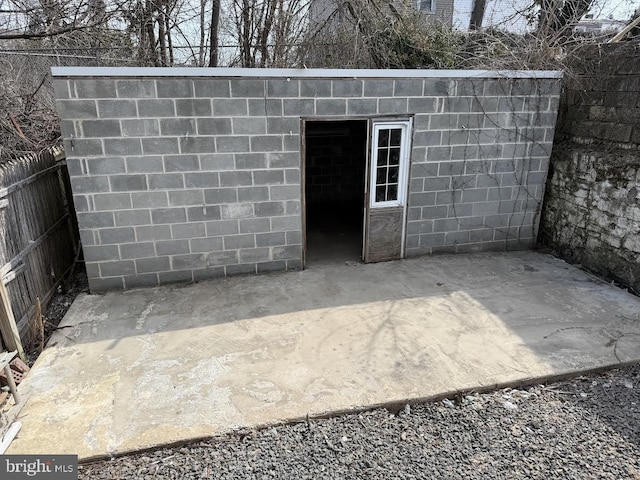 view of outbuilding featuring an outdoor structure and fence